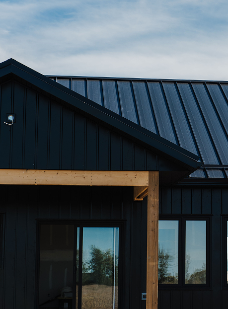 Modern home in Charing Cross Ontario with black standing seam metal roof by Country Towne for sleek curb appeal