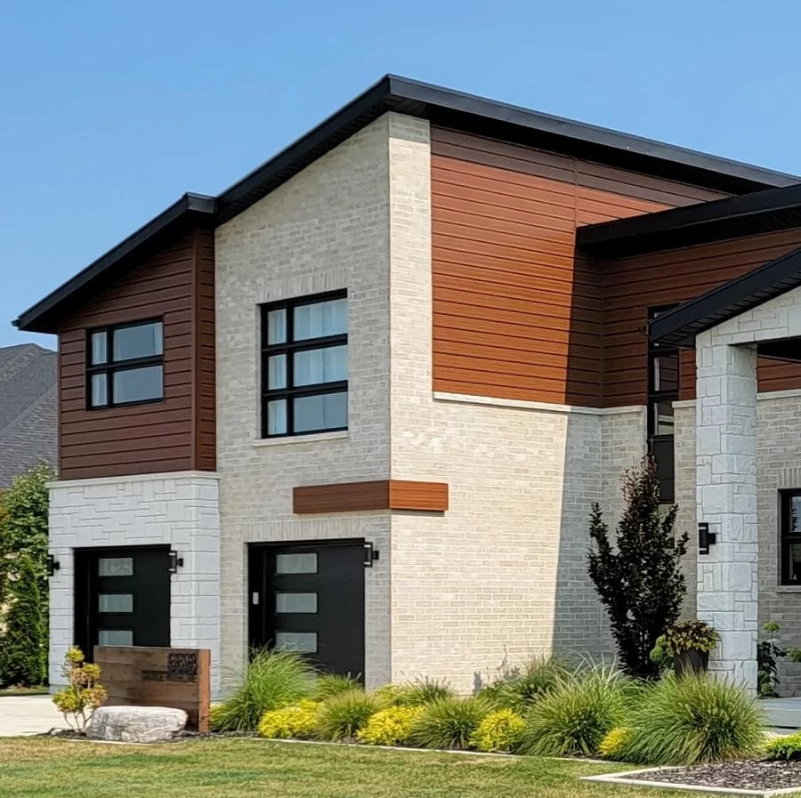 Modern two-story home with espresso woodgrain flat board metal siding and stone façade — premium CountryTowne cladding with natural texture.