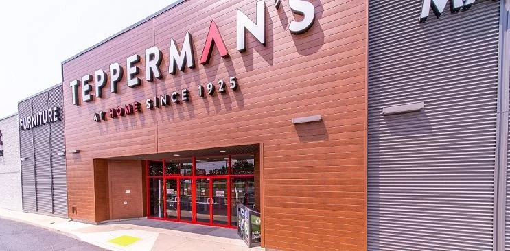 Commercial storefront in Chatham clad with CountryTowne woodgrain flat board planks — modern metal siding with natural warmth and clean lines.