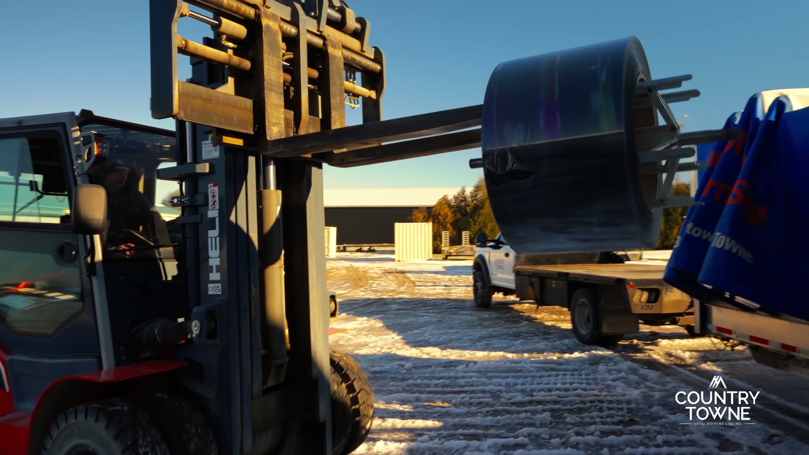 Country Towne forklift moving a metal coil for contractor delivery