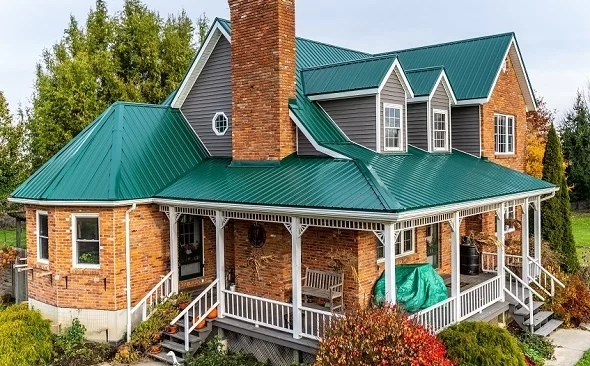 Traditional brick home with green Tuff Rib metal roofing — CountryTowne exposed fastener panels offering durable protection and classic rural charm.