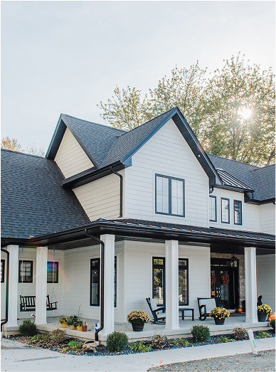Modern farmhouse in Guelph Ontario with an accent snaplock metal roof by Country Towne, adding bold architectural lines