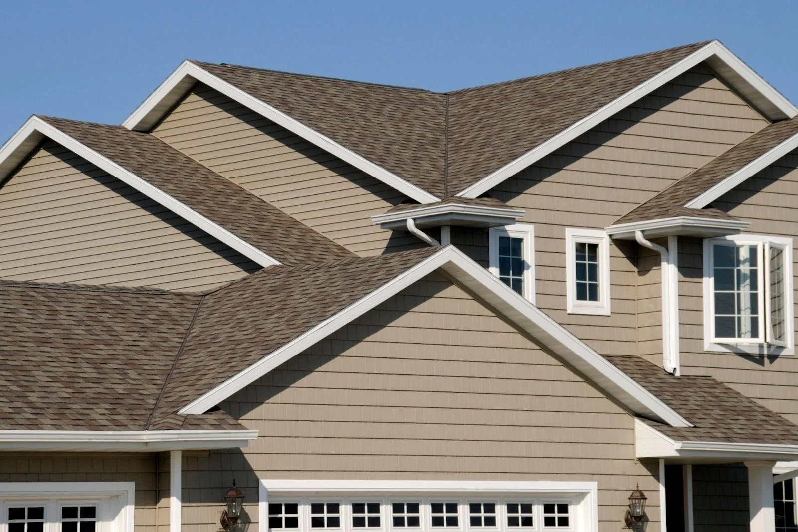 A big house with a shingle roof.