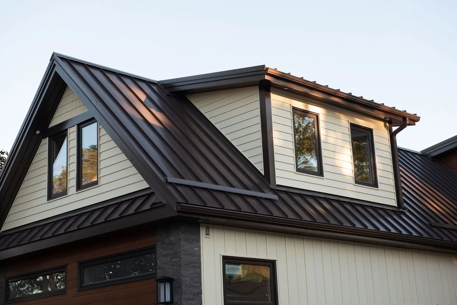 A sloped metal roof with snow stoppers.